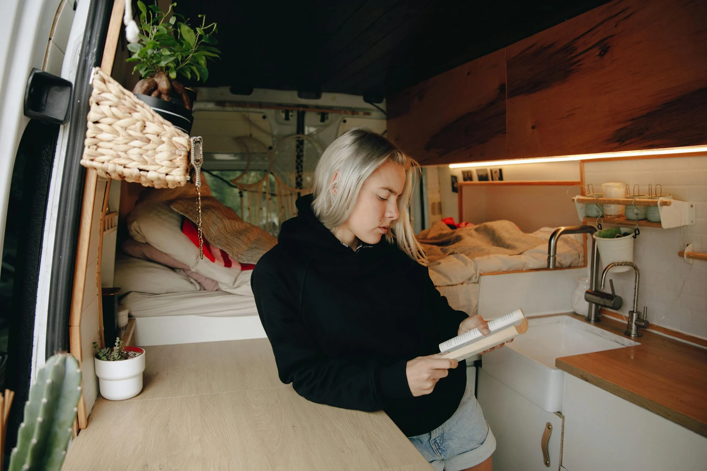 Young woman reading in van